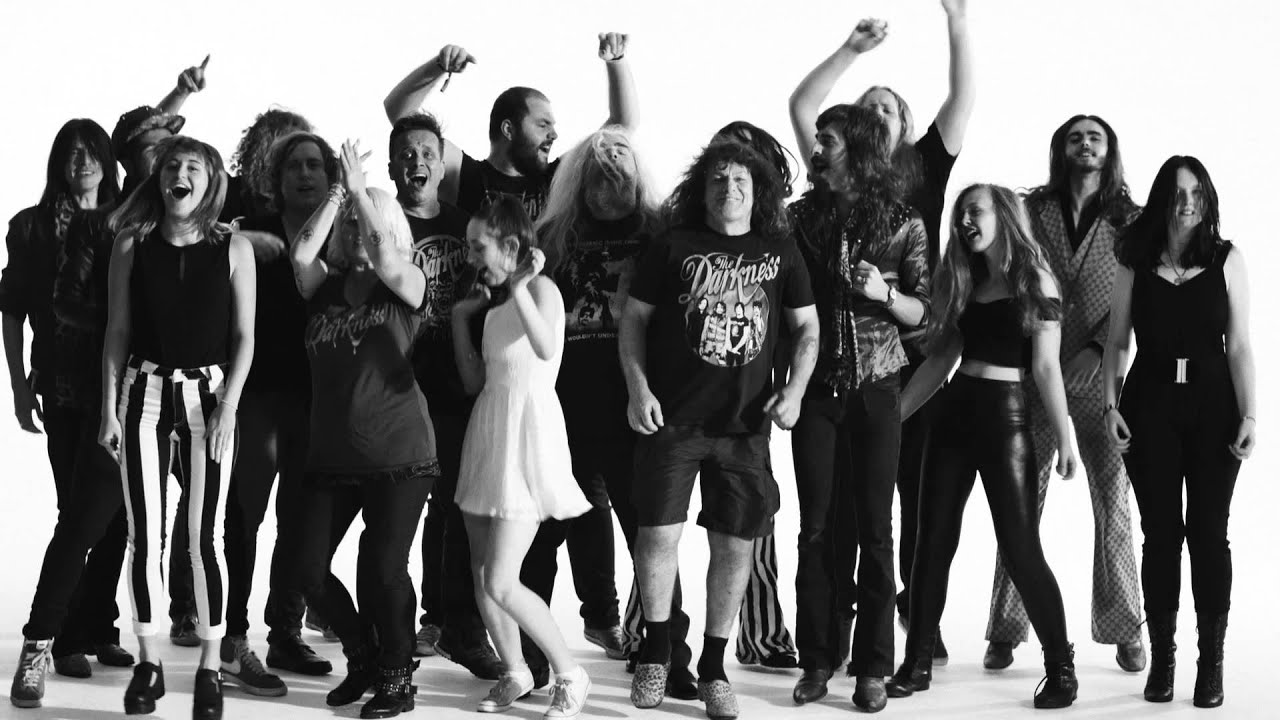A glorious image of some humans from the music video for Last of our kind from The Darkness